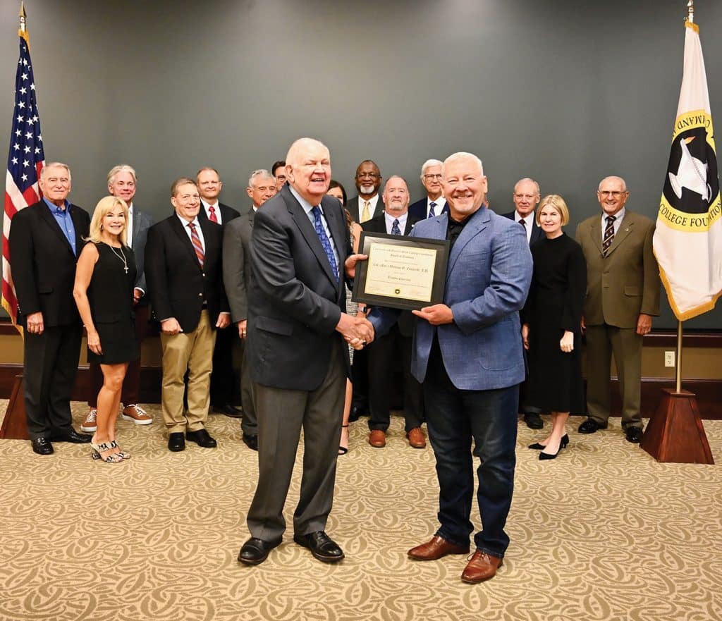 CGSC Foundation Chair Maj. Gen. (Ret.) Chris Hughes, right, presents Col. (Ret.) Bill Eckhardt with an award signifying his designation as "Trustee Emeritus."