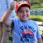 Odeh Alwrikat, age 7, son of CGSOC international military student Lt. Col. Emad Alwrikat from Jordan, holds up his first fish during the fourth annual International Family Fishing Derby on Sept. 7, 2024, at Fort Leavenworth's Merritt Lake.
