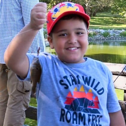 Odeh Alwrikat, age 7, son of CGSOC international military student Lt. Col. Emad Alwrikat from Jordan, holds up his first fish during the fourth annual International Family Fishing Derby on Sept. 7, 2024, at Fort Leavenworth's Merritt Lake.