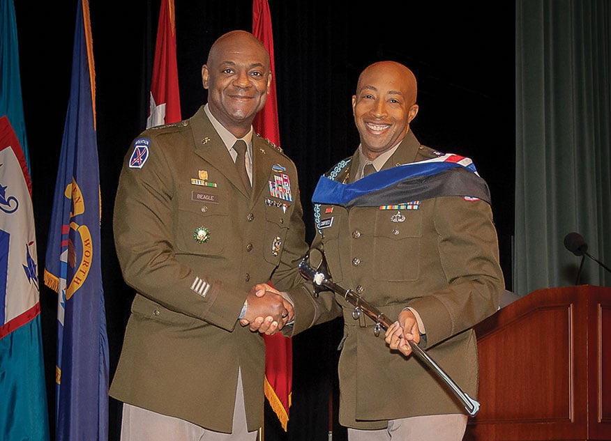 Maj. Audley Campbell, right, receives an engraved officer’s saber for the Col. Thomas Felts Leadership Award from CGSC Commandant Lt. Gen. Milford H. Beagle Jr., during the SAMS Class of 2024 graduation ceremony at Fort Leavenworth, Kansas, May 23, 2024.