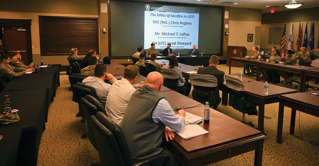 Seated from right, Maj. Gen. (Ret.) Chris Hughes, chairman of the CGSC Foundation; Michael T. Loftus, instructor in the Department of Command and Leadership, U.S. Army Command and General Staff College; and Chaplain (Lt. Col.) Jared Vineyard, ethicist, Center for Army Leadership and deputy command chaplain, Combined Arms Center, Fort Leavenworth, Kansas, lead a discussion panel entitled "The Ethics of Sacrifice in LSCO" during the CGSC Military Ethics Symposium, April 1, 2025. 