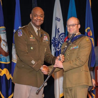 Lt. Gen. Milford H. Beagle, Jr., commanding general of the Combined Arms Center and commandant of Command and General Staff College, left, presents the Col. Thomas Felts Leadership Award for the top AMSP student to Maj. Nicholas Barber, Australia, during the School for Advanced Military Studies graduation on May 22, 2025.
