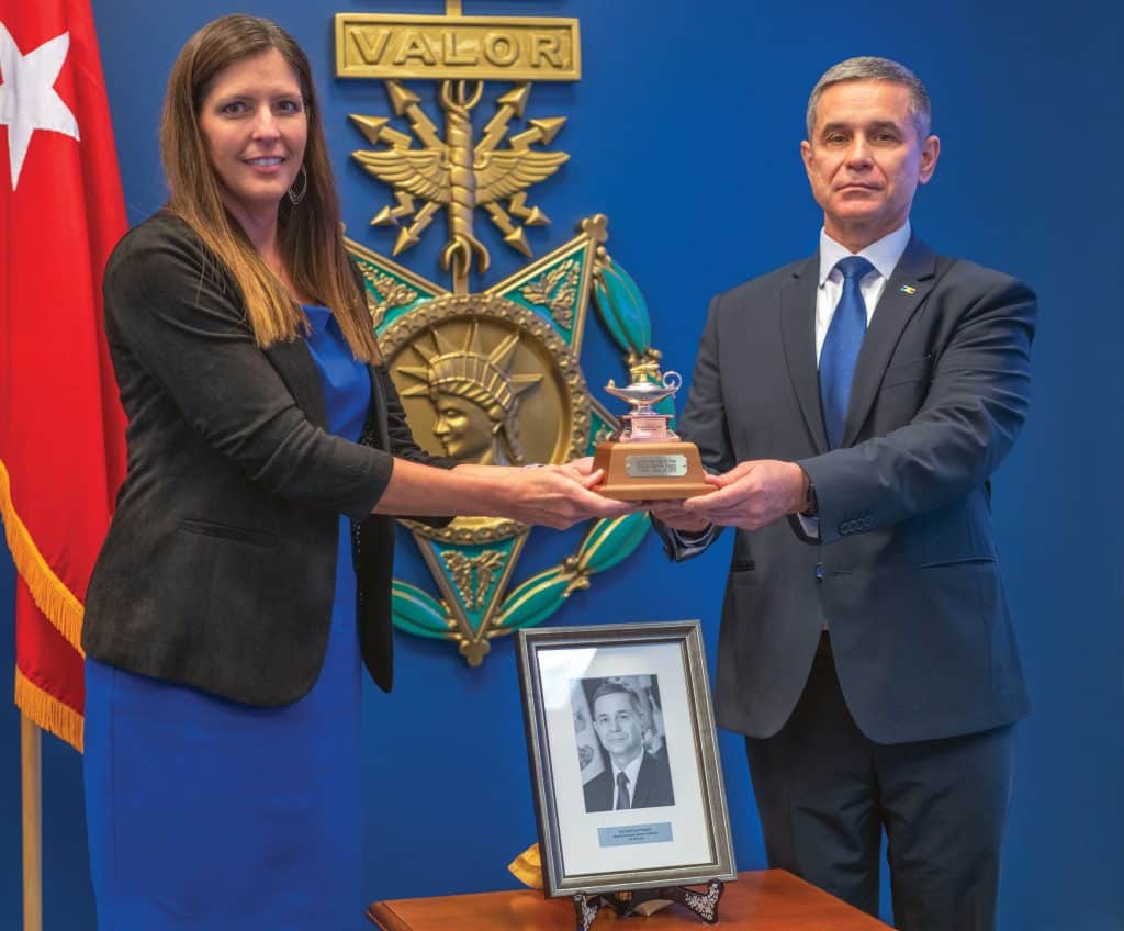 CGSC Foundation President/CEO Lora Morgan presents Anatolie Nosatîi, Minister of Defence of the Republic of Moldova, with a gift of a miniature Fort Leavenworth Lamp designating him as an honorary life constituent of the CGSC Foundation during the International Hall of Fame induction ceremony in the Pentagon Hall of Heroes, Arlington, Va. Aug. 20, 2025. (U.S. Army photo by Christopher Kaufmann)