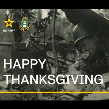 image of a WWII Soldier behind a machine gun eating a turkey leg