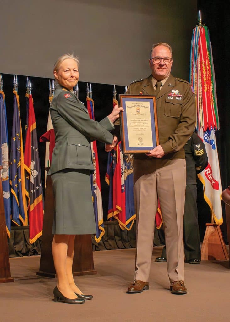 IHOF-260409-2-wLieutenant General Ingrid Gjerde, Chief of Defence Staff, Vice Chief of Defence, Norwegian Armed Forces, left, is presented the order inducting her to the U.S. Army Command and General Staff College International Hall of Fame by Lt. Gen. Jim Isenhower, commanding general, U.S. Army Combined Arms Command and Fort Leavenworth, right, during a ceremony April 9, 2026, on Fort Leavenworth. (U.S. Army photo by Jim Shea)