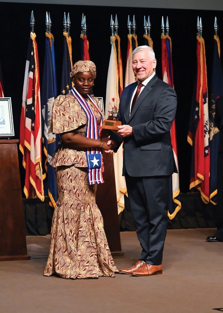 CGSC Foundation Chair Maj. Gen. (Ret.) Chris Hughes, right, presents Minister Geraldine Janet George, Minister of Defense of Liberia, with a gift of a miniature Fort Leavenworth Lamp designating her as an honorary life constituent of the CGSC Foundation during the International Hall of Fame induction ceremony April 9, 2026, at the Lewis and Clark Center, Fort Leavenworth, Kansas.