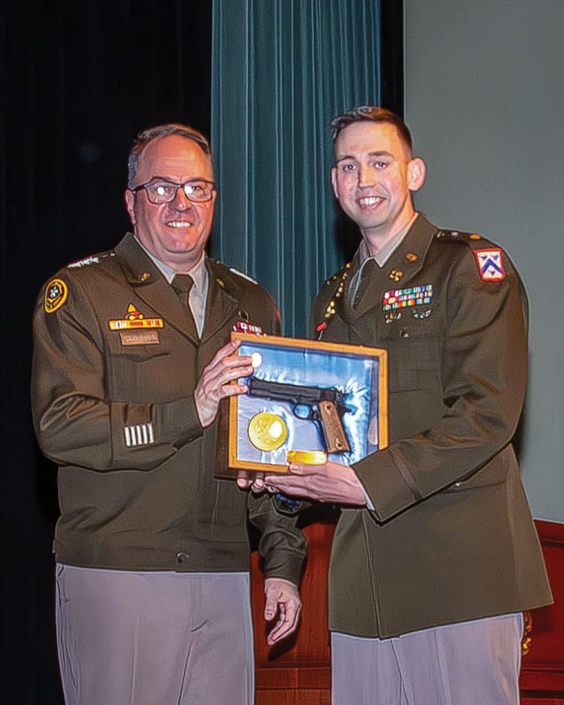 Major Andrew L. Scholl, right, receives the General George C. Marshall Award from ceremony guest speaker Lt. Gen. Jim Isenhower, commanding general, U.S. Army Combined Arms Command and Fort Leavenworth, honoring him as the top U.S. graduate in the Command and General Staff Officers Class of 2026 during the graduation ceremony May 29, at the Lewis and Clark Center.
