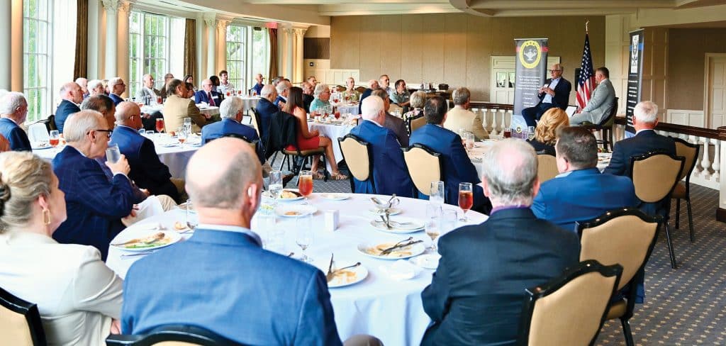 Charlie Gilbert, left, director of global intelligence for Gavin de Becker & Associates and former deputy director of the National Clandestine Service for the CIA, discusses intelligence activities with Simons Center Director Todd Schmidt during the Arter-Rowland National Security Forum luncheon event at the Carriage Club in Kansas City on July 16, 2026.