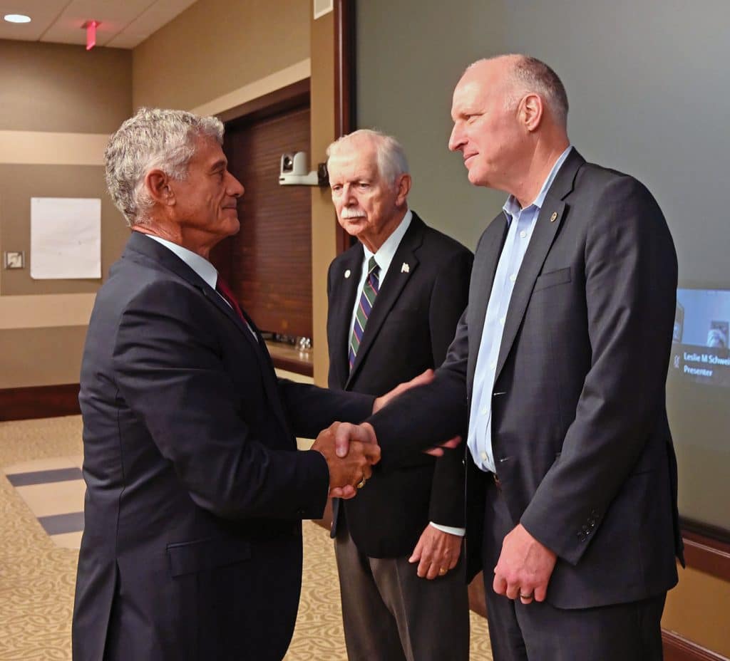New CGSC Foundation and Alumni Association Chair Lt. Gen. (Ret.) Robert L. Caslen, left, welcomes two new board members during the Foundation board meeting on Sept. 29, 2026, in the Arnold Conference Room of the Lewis and Clark Center on Fort Leavenworth, Kansas. From left, Brig. Gen. (Ret.) Jerry Neff and Joe Close, receive their Foundation lapel pins from Caslen.