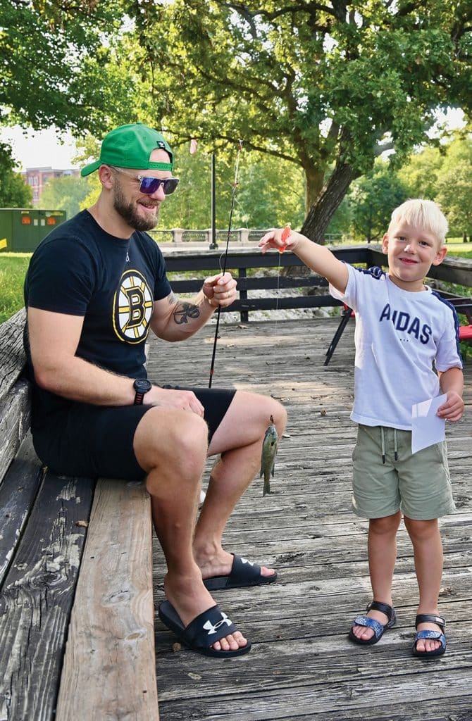 Dominik Janecek, 5, son of CGSOC international military student Maj. Jan Janecek, left, shows off his catch during the International Family Fishing Derby on Sept. 19, 2026, at Fort Leavenworth's Merritt Lake.