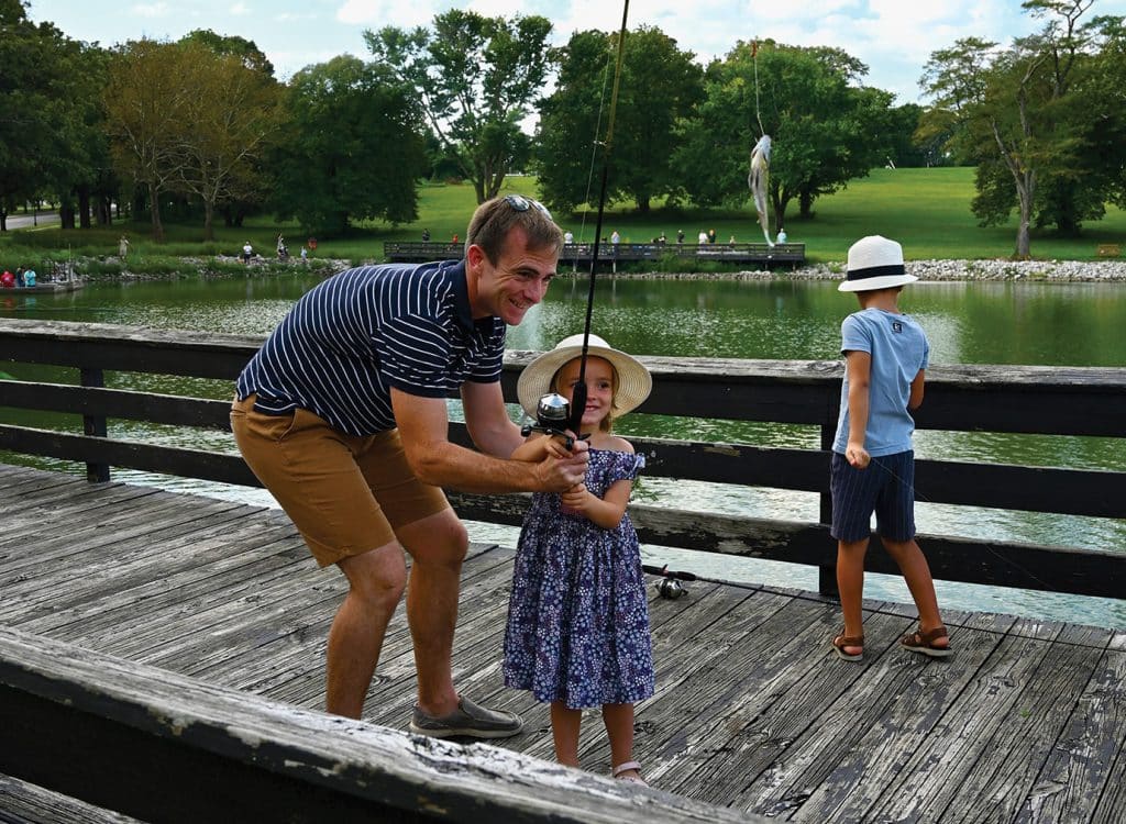 Maj. Charles Allegre, CGSOC international military student from France, helps his daughter Gabrielle, 4, pose for a photo with her first fish during the sixth annual International Family Fishing Derby on Sept. 19, 2026.