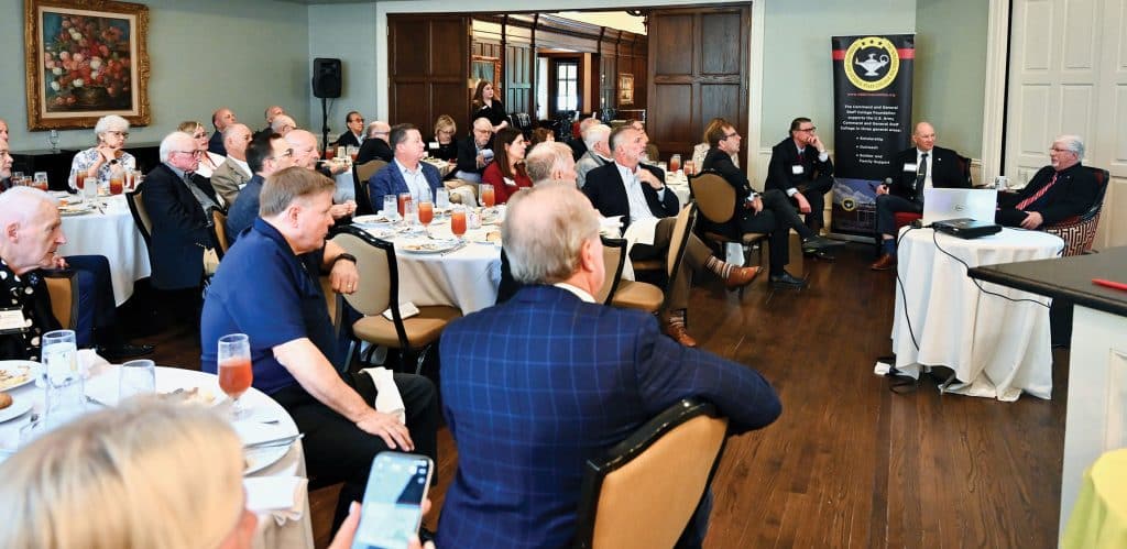 Keith Prather, managing director of Armada Corporate Intelligence, seated right, discusses the impact of current conflict in the Straits of Hormuz with Simons Center Deputy Director John Nelson during the Arter-Rowland National Security Forum luncheon event at the Carriage Club in Kansas City on Oct. 15, 2026.