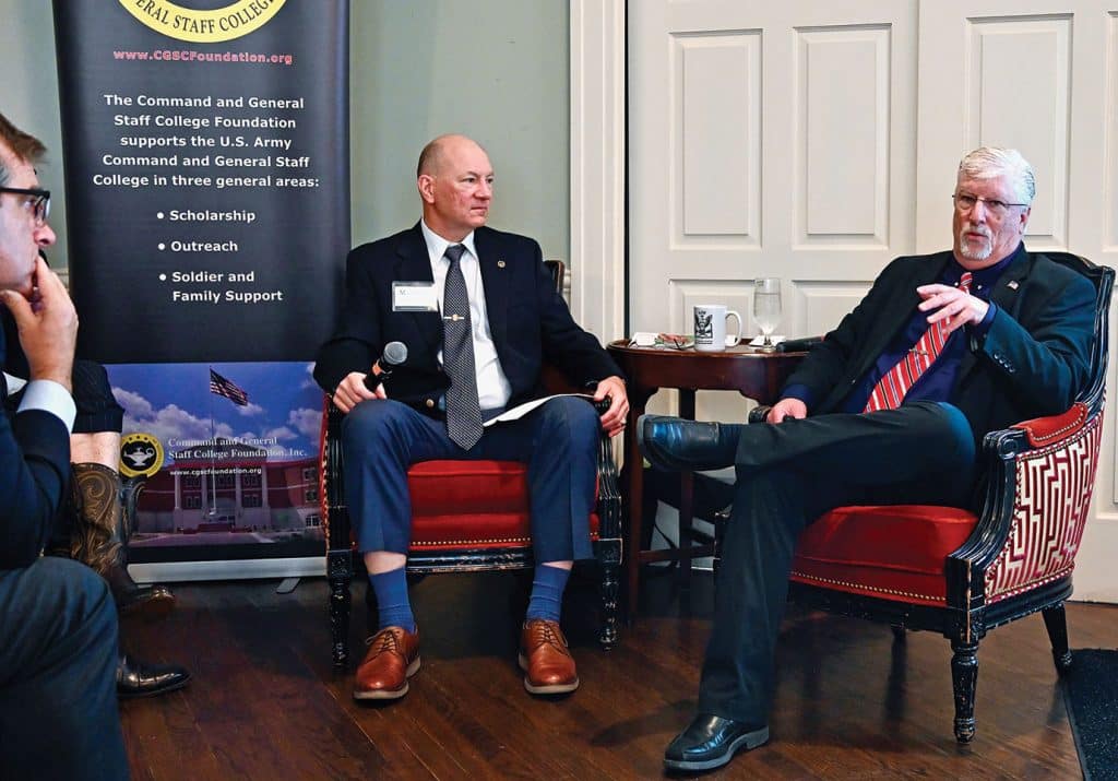 Keith Prather, managing director of Armada Corporate Intelligence, seated right, discusses the impact of current conflict in the Straits of Hormuz with Simons Center Deputy Director John Nelson during the Arter-Rowland National Security Forum luncheon event at the Carriage Club in Kansas City on Oct. 15, 2026.
