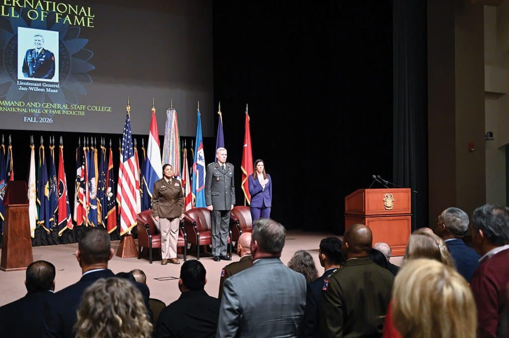 From left, Maj. Gen. Patricia Wallace, deputy commanding general, U.S. Army Reserve, U.S. Army Combined Arms Command and Fort Leavenworth, Lt. Gen. Jan-Willem Maas, commander, Joint Support Command, Netherlands, and CGSC Foundation President/CEO Lora Morgan stand at attention during the national anthem at the start of the CGSC International Hall of Fame induction ceremony for Maas, Oct. 16, 2026, at Fort Leavenworth, Kansas. (photo by Mark H. Wiggins/CGSC Foundation and Alumni Association)